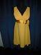 Olivia DeHavilland gold short sleeve dress withsash from Sydney Guilaroff