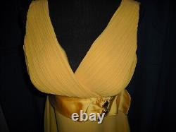 Olivia DeHavilland gold short sleeve dress withsash from Sydney Guilaroff