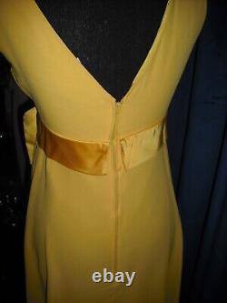 Olivia DeHavilland gold short sleeve dress withsash from Sydney Guilaroff