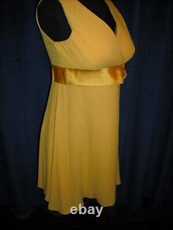 Olivia DeHavilland gold short sleeve dress withsash from Sydney Guilaroff