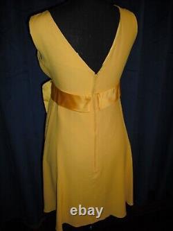 Olivia DeHavilland gold short sleeve dress withsash from Sydney Guilaroff